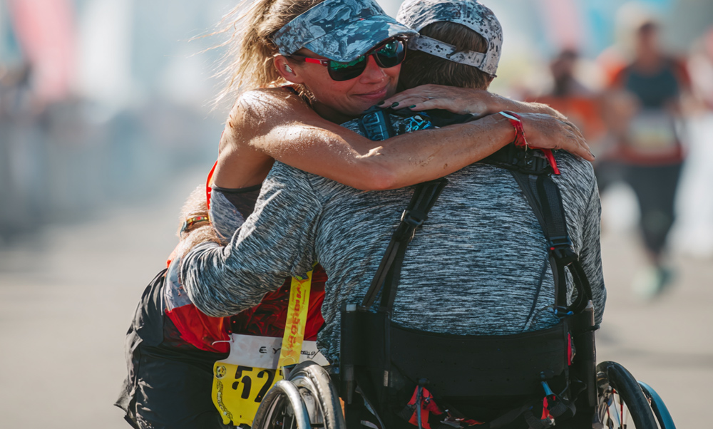 Wheelchair racer celebrating with supporter representing life insurance for disabled individuals