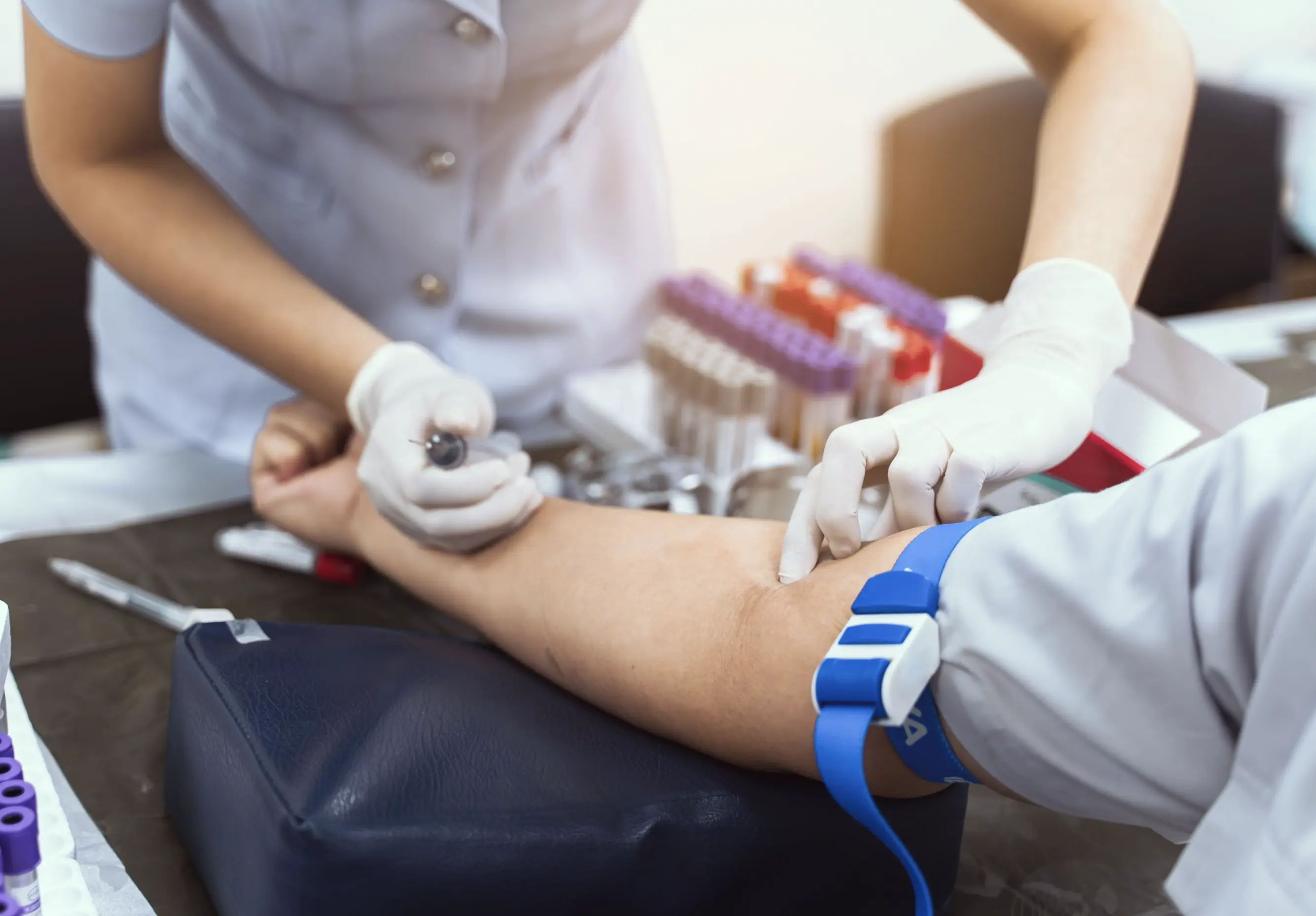 Healthcare professional taking blood sample for HbA1c diabetes test essential for life insurance