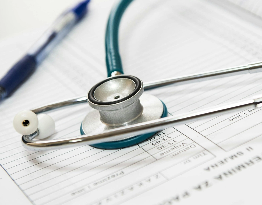 Professional stethoscope on medical documents representing private medical insurance coverage
